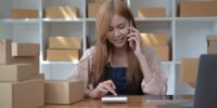 Small start-up business owners using computers and phones at work, salespeople, checking production