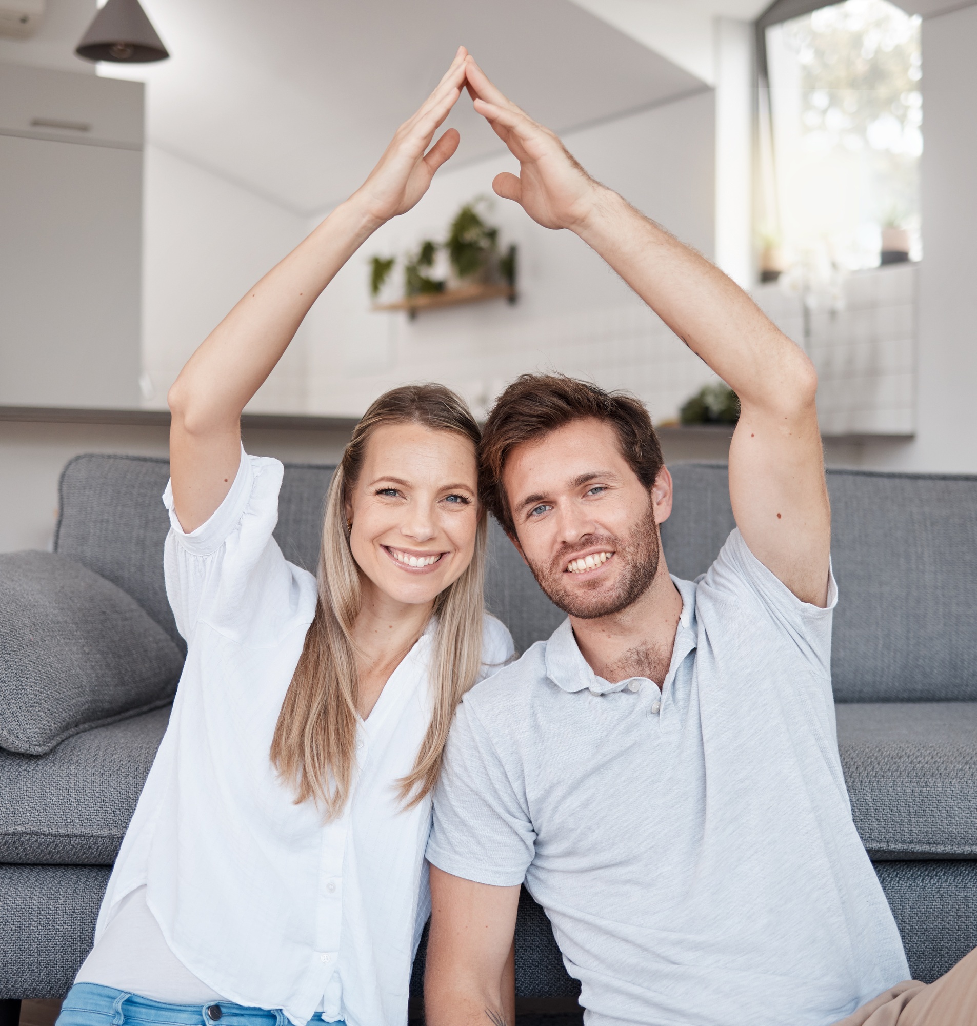Real estate, security and couple with roof hands for safety, investment and insurance in their hous