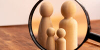 Small wooden figures of family members close up. Family relationship symbol